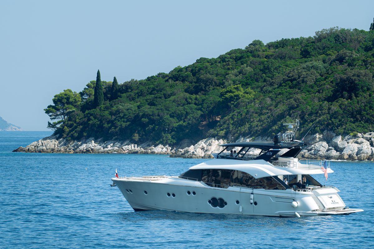 A sleek luxury yacht anchored in a secluded bay, illustrating ideal luxury yacht routes Croatia for 2026.