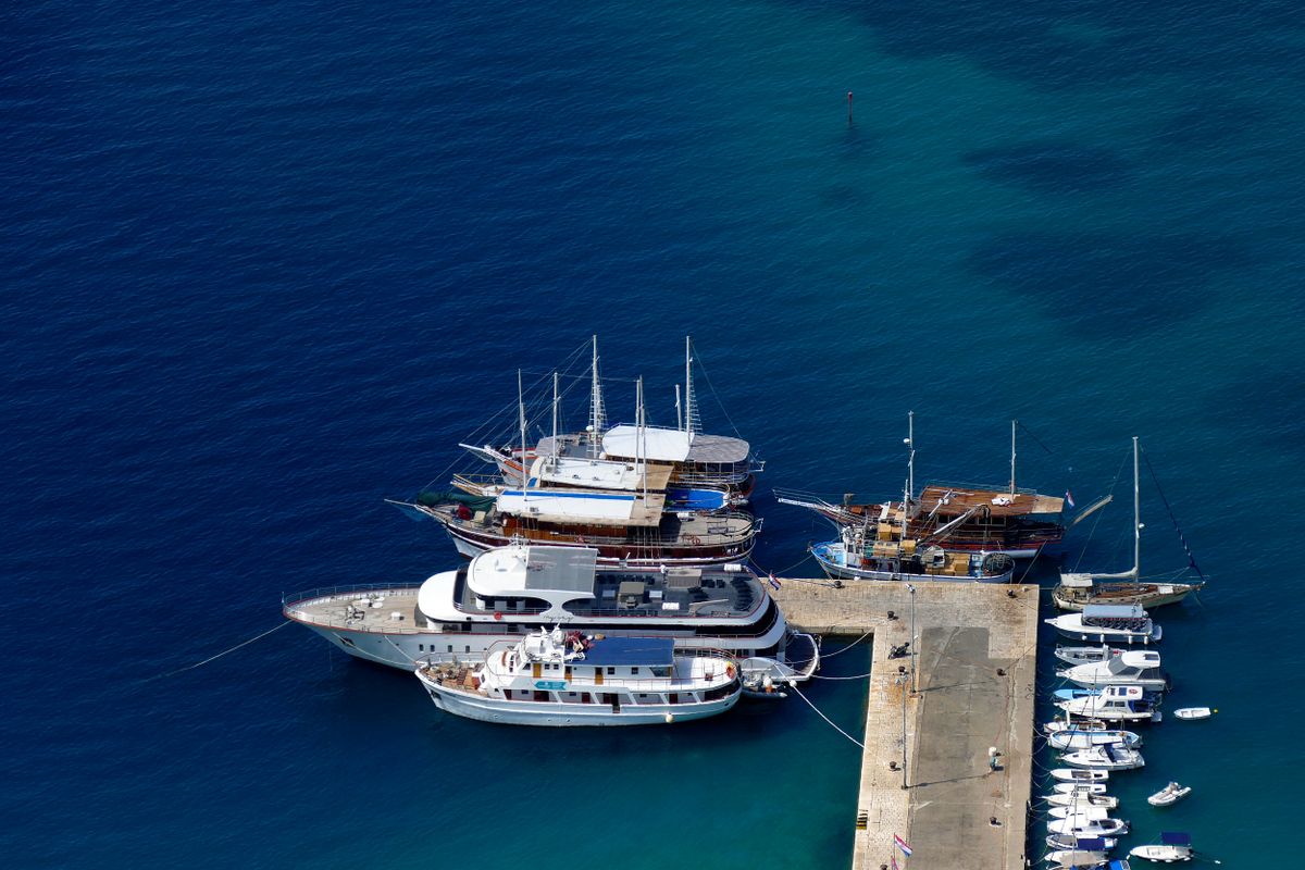 A happy family on deck of a luxury yacht in Croatia, enjoying a family yacht charter Croatia vacation.