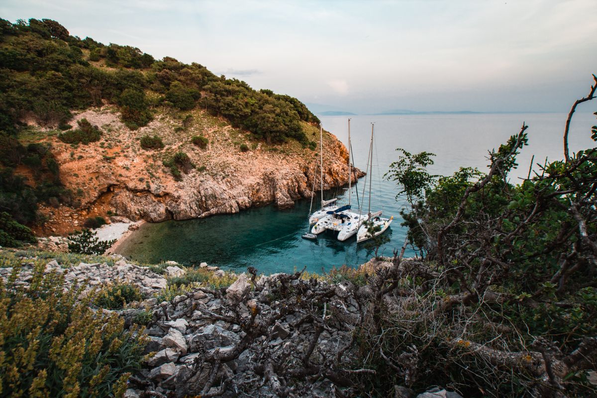 Luxury motor yacht anchored near a secluded blue bay during an island hopping Croatia yacht holiday.