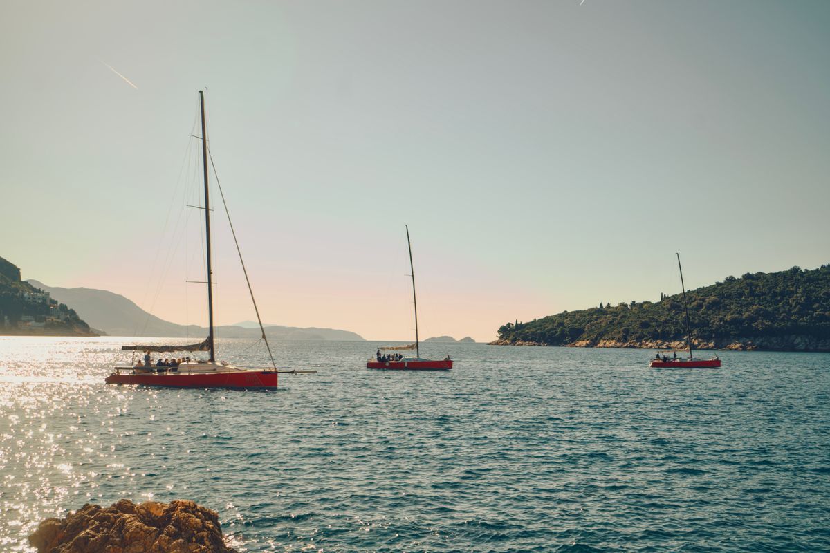 Luxury yacht anchored near sun-drenched islands during an ultimate island hopping Croatia yacht holiday.