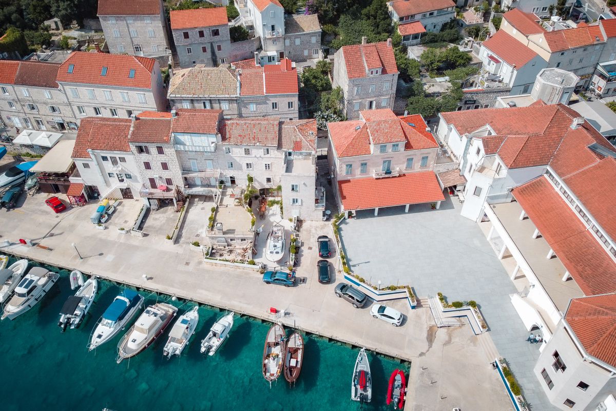 A family enjoying a swim from a catamaran, perfect for a family yacht charter Croatia vacation.
